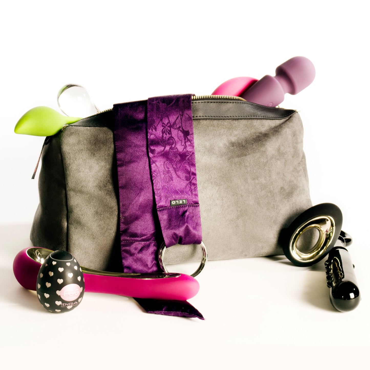 A grey Tallulah Locking Toy Bag by Liberator against a white background with toys coming out of it.