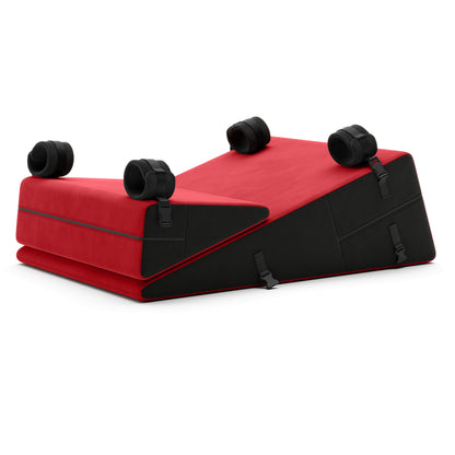 A set of red Bondage ramp and wedge, Bedroom Furniture by Liberator with handcuffs on a white background.
