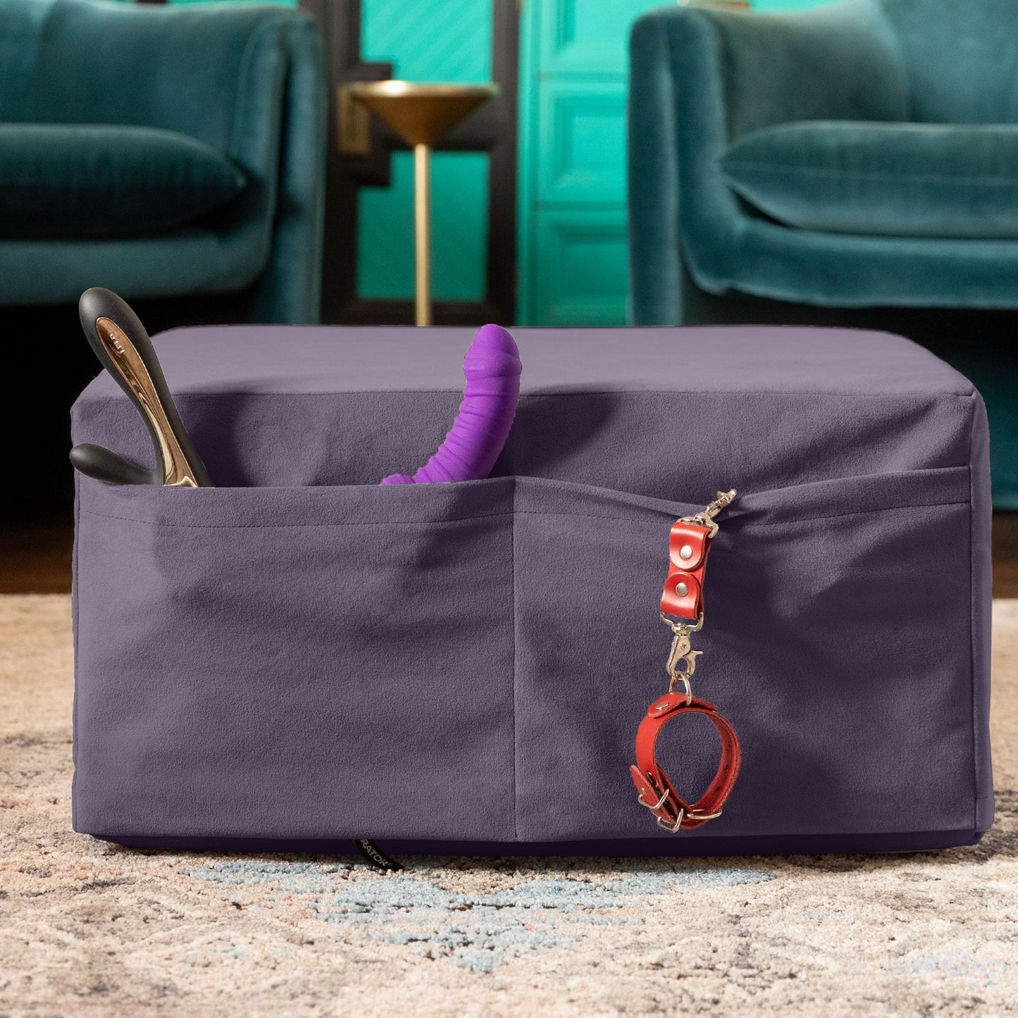 An Aubergine Center Stage ottoman, Bedroom Furniture by Liberator folded up showing toys stored in the pockets in a livingroom.