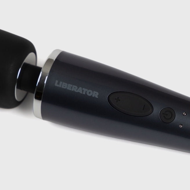 The close up view of a black DeJour Vibrating Wand bedroom toy by Liberator on a white background.