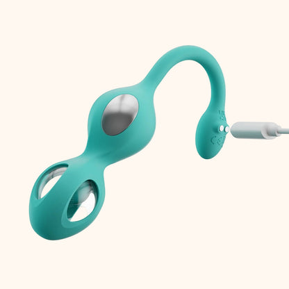 A green Elektra-App-controlled E-Stim Kegel Training set against a white background showing how it charges.