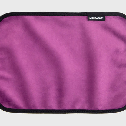 A aubergine Fascinator Splashproof Throws, Bedroom Furniture by Liberator unrolled up against a white background.