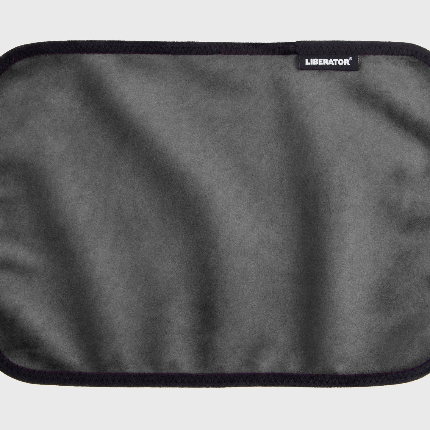 A black Fascinator Splashproof Throws, Bedroom Furniture by Liberator unrolled up against a white background.