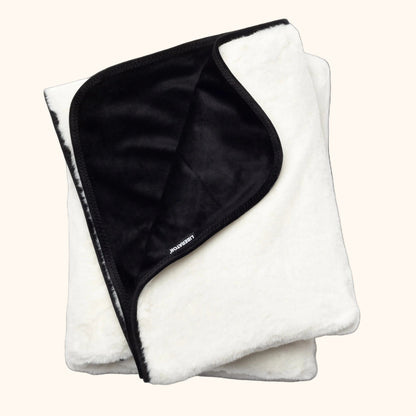 A white faux fur Fascinator Splashproof Throws, Bedroom Furniture by Liberator against a white background.