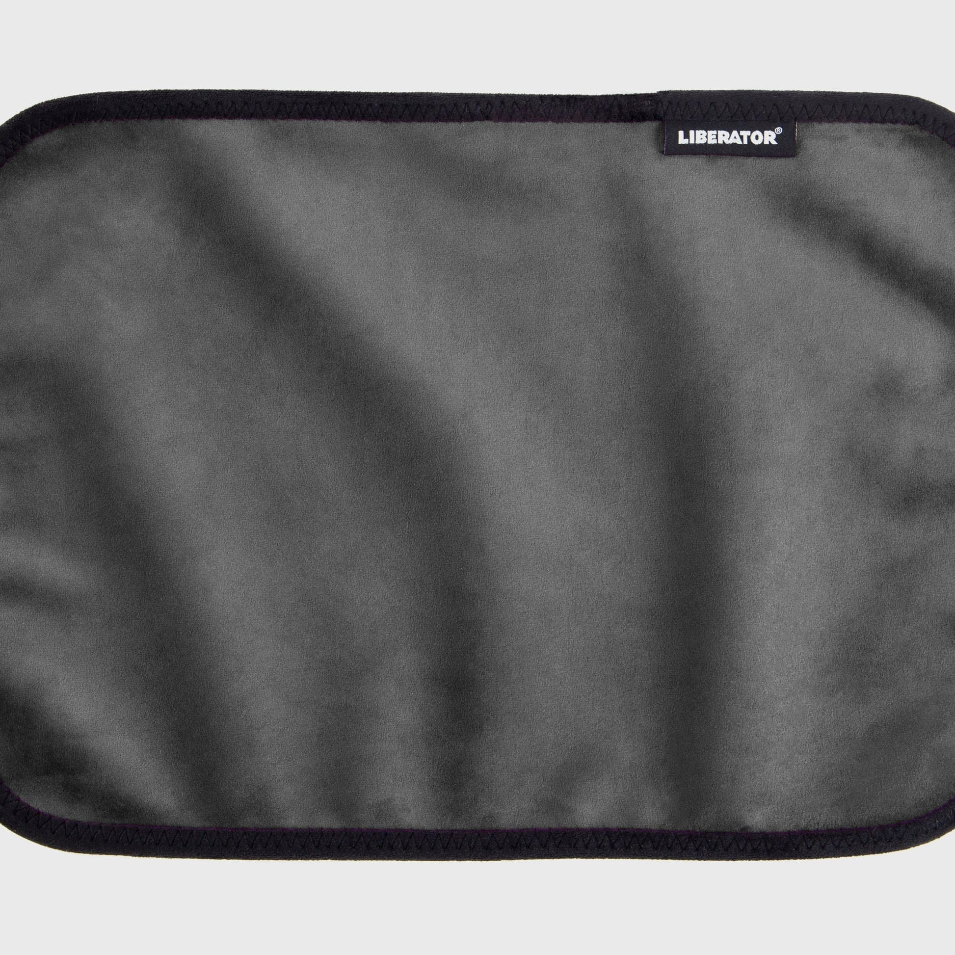 A grey Fascinator Splashproof Throws, Bedroom Furniture by Liberator unrolled up against a white background.