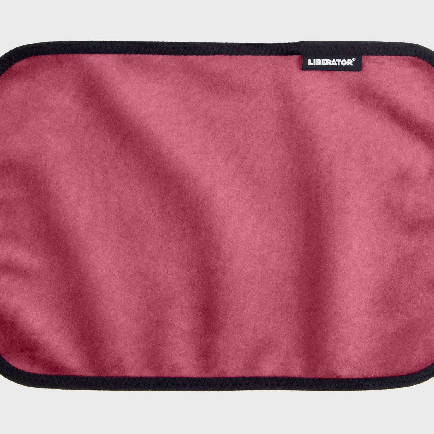 A merlot Fascinator Splashproof Throws, Bedroom Furniture by Liberator unrolled up against a white background.