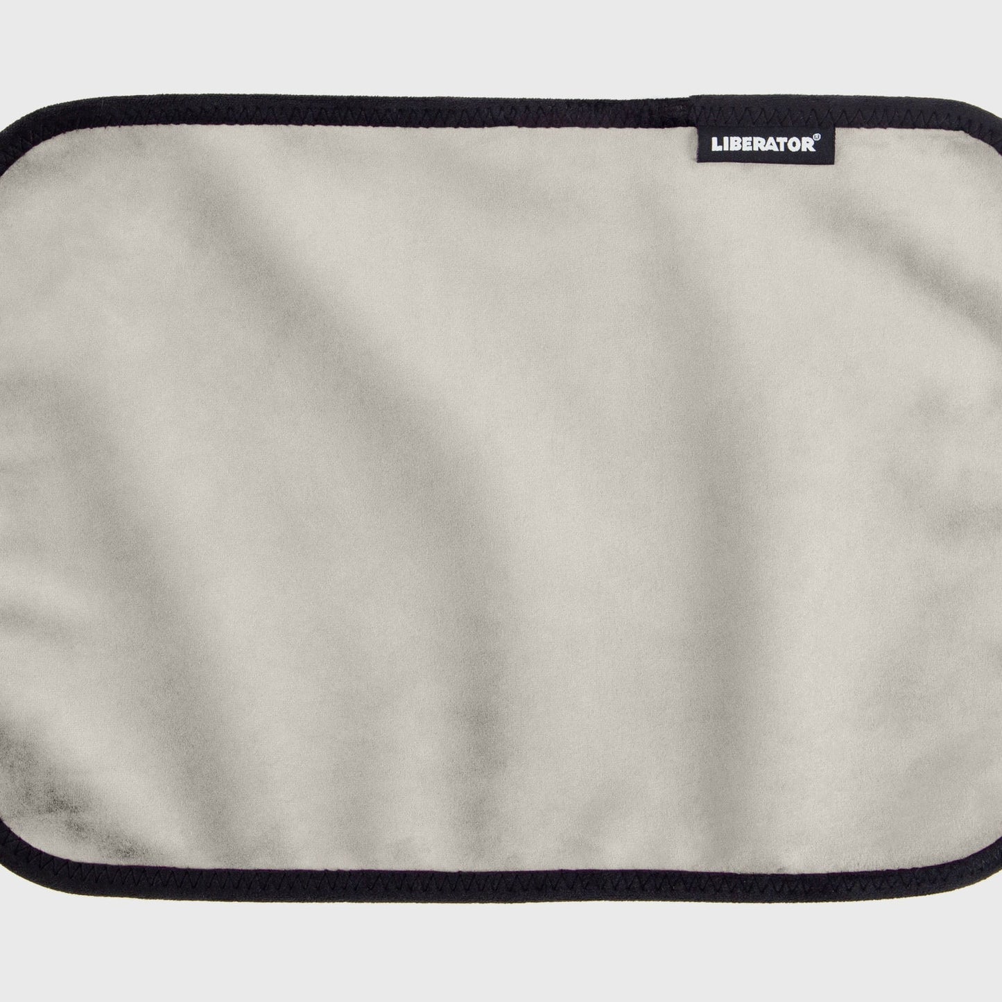 A white cream Fascinator Splashproof Throws, Bedroom Furniture by Liberator unrolled up against a white background.