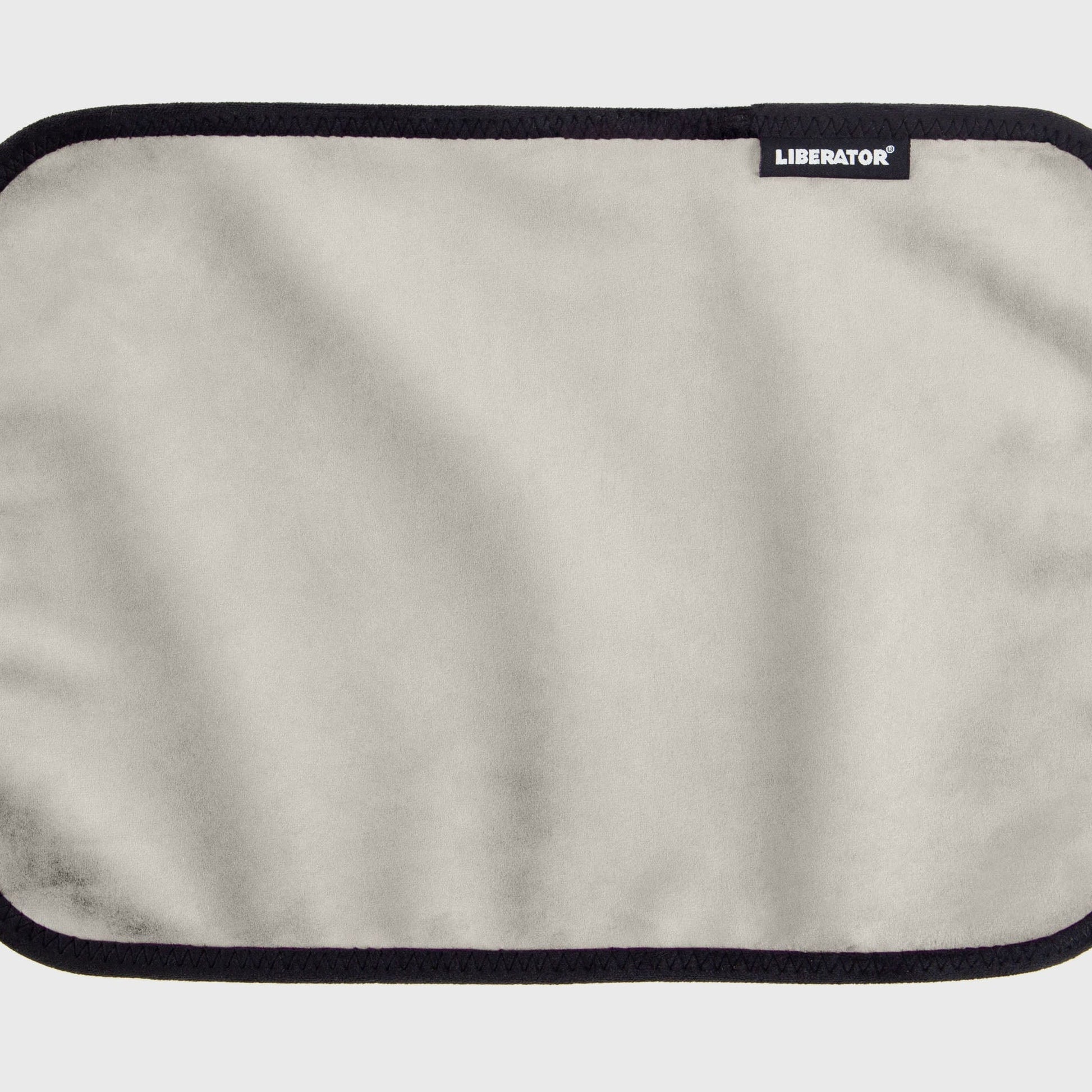 A white cream Fascinator Splashproof Throws, Bedroom Furniture by Liberator unrolled up against a white background.