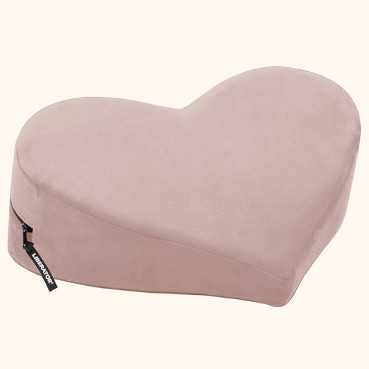 A rose colored Heart Wedge, Bedroom Furniture by Liberator against a white background.