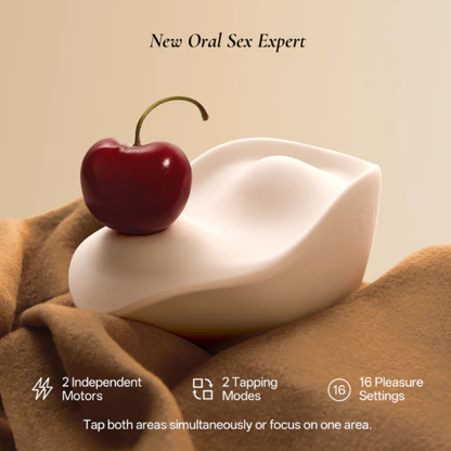 A white Kiss dual-tapping vibrator by Liberator with a cherry sitting on it with a description of the toy.