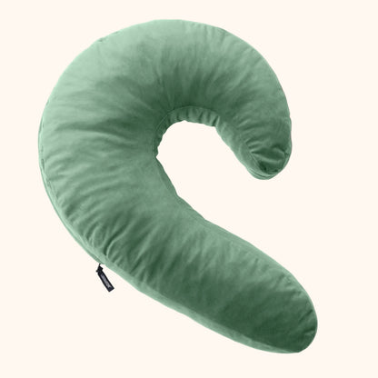 A sage Lune Snuggle curved Pillow, Bedroom Furniture by Liberator against a white background.