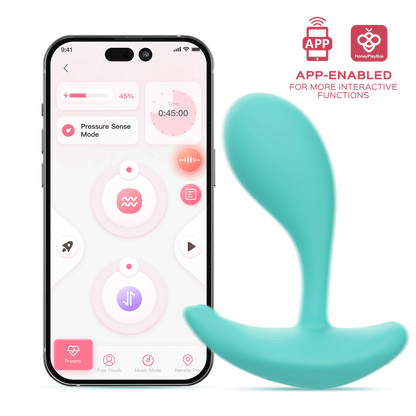 A light blue OLY 2 Pressure Sensing APP-enabled Wearable Clit & G Spot Vibrator sitting next to a phone against a white background showing it is app-enabled.
