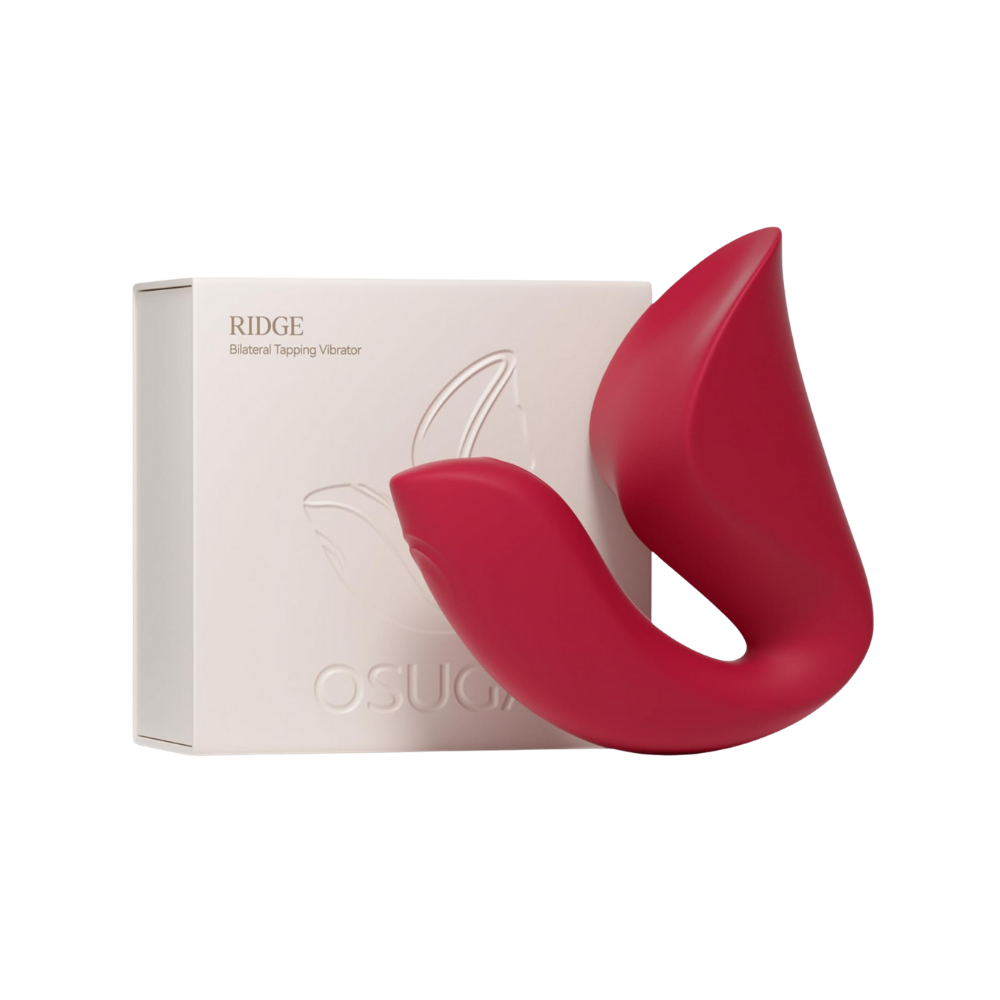 A red Ridge Dual Action Vibrator by Liberator next to the box.