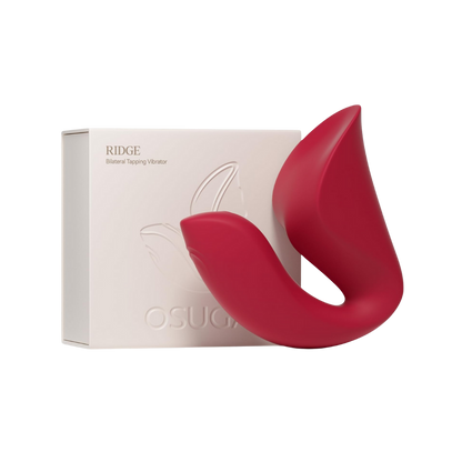 A red Ridge Dual Action Vibrator by Liberator next to the box.