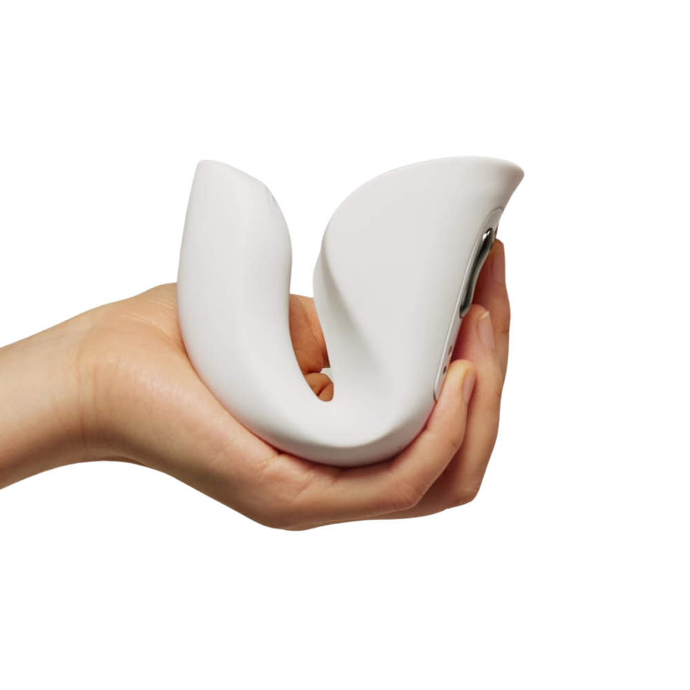 A hand holding a white Ridge Dual Action Vibrator by Liberator.