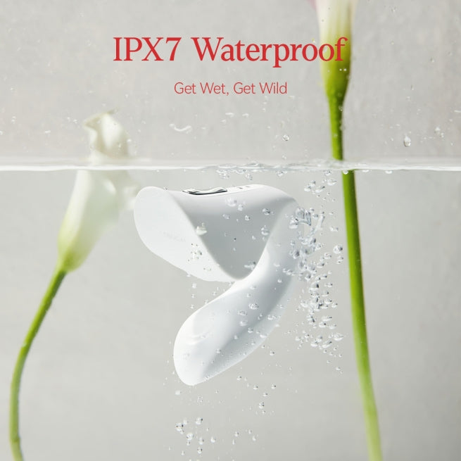 A white Ridge Dual Action Vibrator by Liberator in water showing its waterproof.