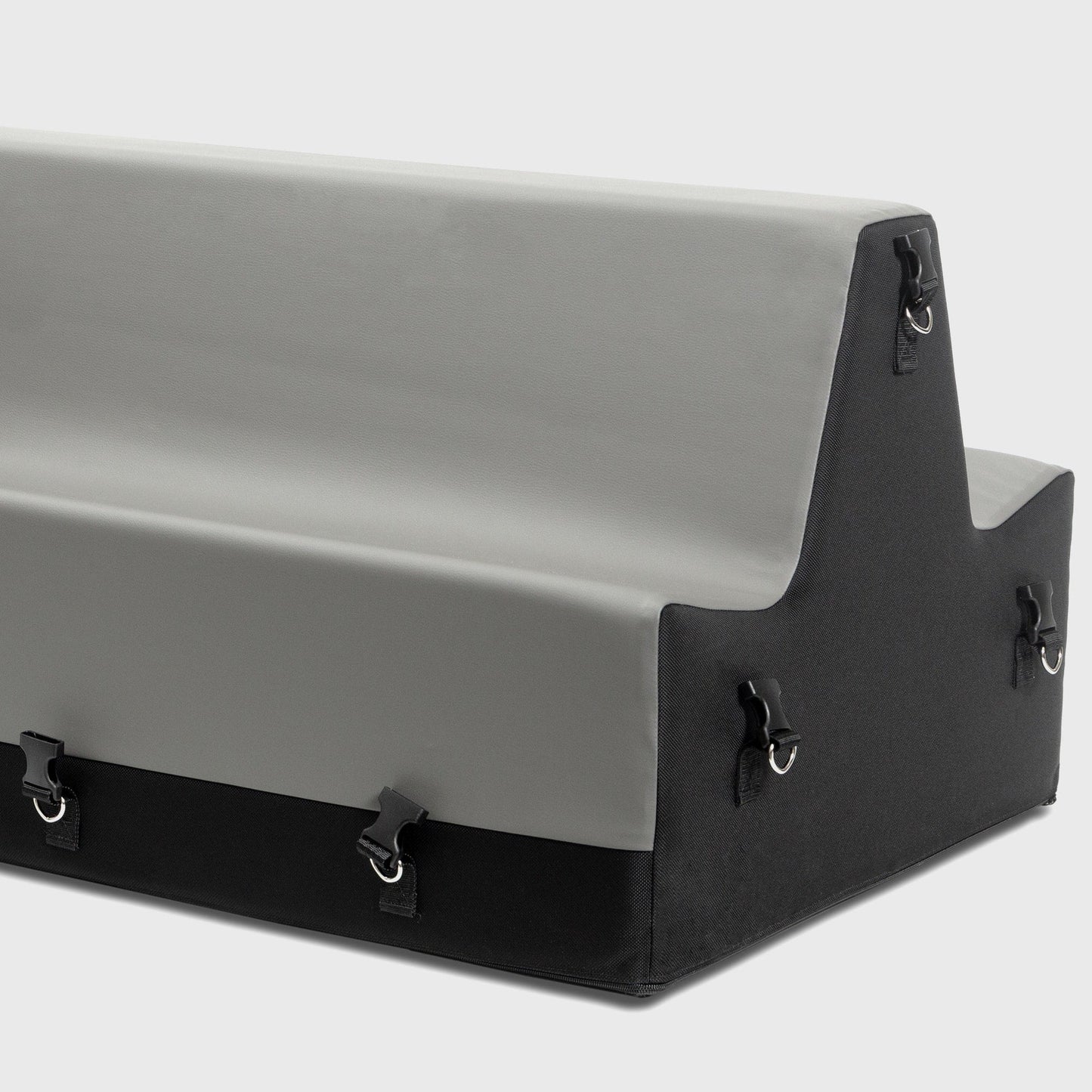 A grey and black Steed Spanking Bench bedroom furniture by Liberator  with cuffs against a white background showing the connectors where the cuffs attach.