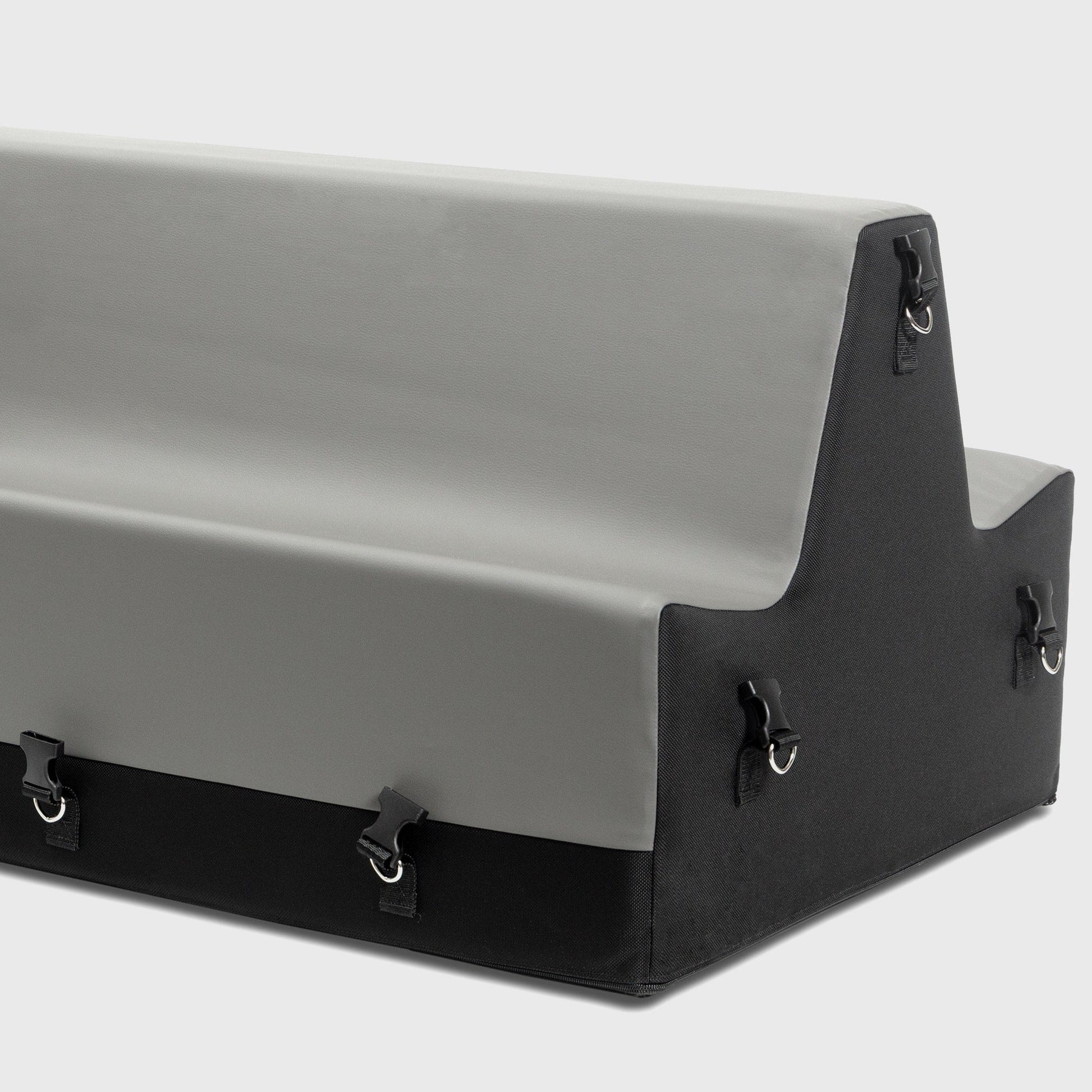 A grey and black Steed Spanking Bench bedroom furniture by Liberator  with cuffs against a white background showing the connectors where the cuffs attach.