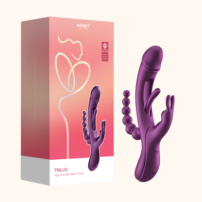 A purple Trilux vibrator against a white background next to the box.